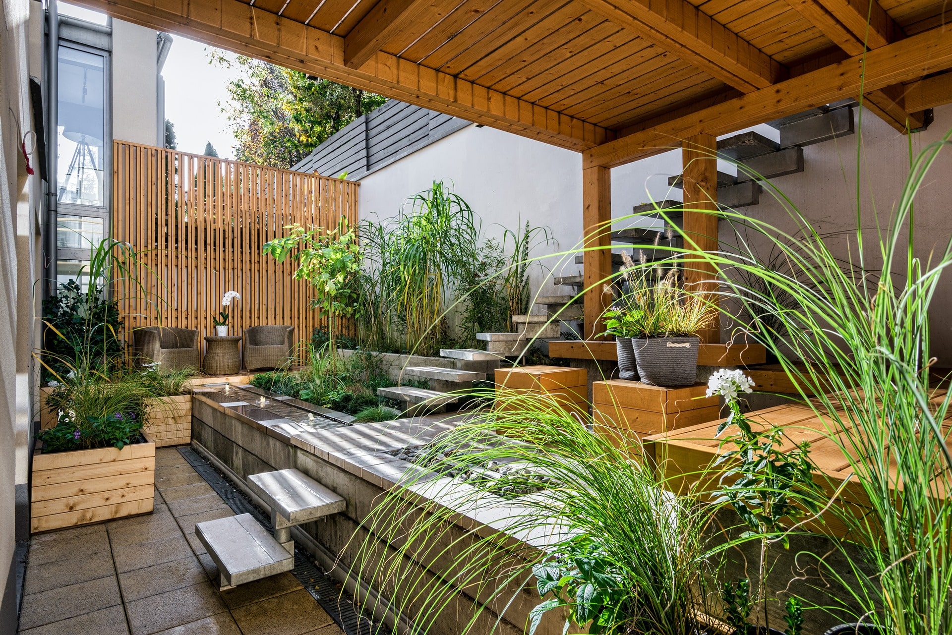 shaded outdoor space with stone and wood and plants